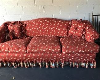 Upholstered sofa in red print.