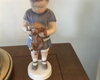 . . . a close up of the figure -- boy with puppy