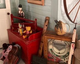 Antique toys, brass boat propeller, pinball machine, wagon wheel