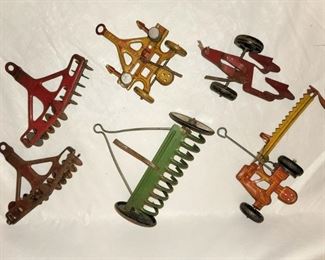 Vintage tin toy plows. 7 pieces. $75