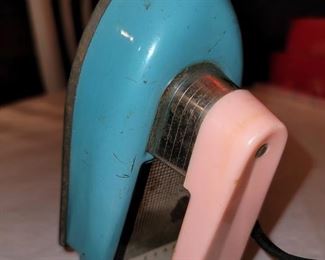 Vintage 1960s "safe" toy iron. Nassau. It warms up when plugged in. $10