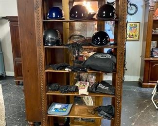 Motorcycle Helmets, Vintage Leather Gloves, Motorcycle Nylon Cover in Bag, and on the top of this wooden shelf is a custom made solid wooden Motorcycle