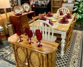 4-Piece, 6-Place Settings of HomeTrends Dishes, 6-Ruby Red Ribbed Wine Glasses, Vintage Small Cabinet with Hand-Painted Floral Design on Doors, White Wooden Dining/Kitchen Table with 6 Chairs