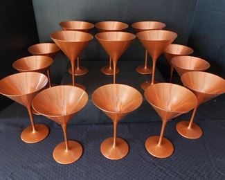 https://ctbids.com/#!/description/share/682339 15 Count: "Glisten" 6 Oz Copper Martini Glasses By Stolzle. "This martini glass features a traditional conical bowl and long, slender stem. A glistening copper color ensures a formal, yet fun, presentation, fit for trendy bars, upscale events, and festive celebrations. Use this iconic glass to serve a classic martini or any signature cocktail."