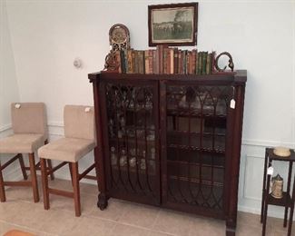 lawyers book case, vintage books, mission smoking stand, bar stools, clock