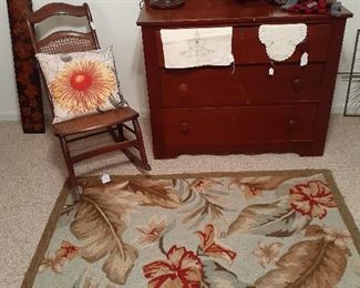 rocking chair, area rug, three drawer vintage dresser, desk lamp