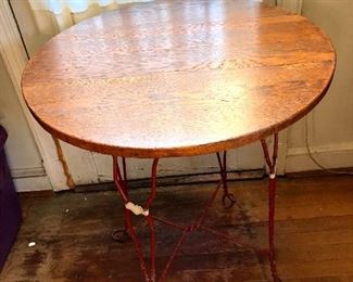 $120  Oak-topped table with painted metal legs. 24" diam, 30" H.  