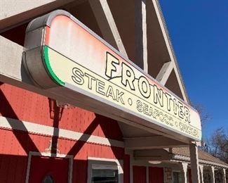 outdoor commercial sign roughly 16' by 2'