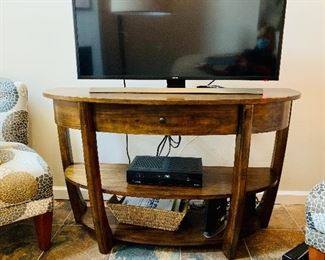 $225; Demilune entertainment console with one drawer and two shelves; 30" H x 20" D x 48" W.