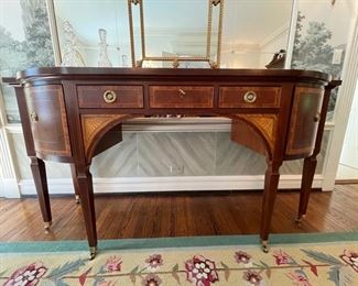 Baker Furniture Stately Home Sheraton bow front inlaid mahogany sideboard. Measures 72ʺ W × 25ʺ D × 37ʺ H. Late 20th century. Photo 1 of 2.