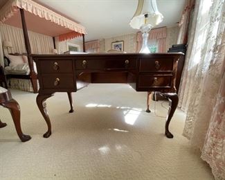 Vintage Sligh flame mahogany and tooled leather cabriole leg writing desk. Measures 60ʺ W × 30ʺ D × 30ʺ H. Photo 1 of 2.