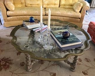 Brass & glass cocktail table with turned weathered-wood legs. Measures 44" W x 17" H.