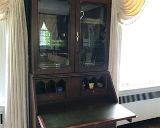 Hekman Federal-style, leather-topped, drop-front secretary with interior lighting. Measures 90" H x 20" D x 38.5" W. Height of desk top when down is 28" H.