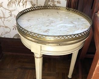 Round lamp table with brass gallery and marble top.