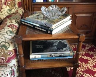 Faux Bamboo Wood side table with 3 cane-toped shelves. Measures 22" L x 14" W x 23" H. Two available.