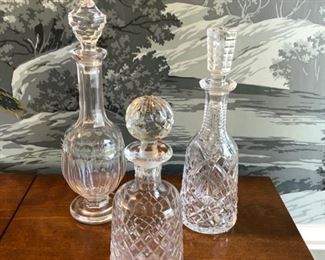 Assorted crystal decanters.
