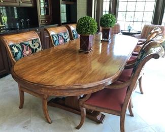 Oval double pedestal dining room table and 8 upholstered armchairs. Table measures 113" L x 46" W x 31" H. Sold separately or together.