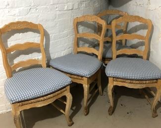 Set of 4 country-style ladderback chairs with rush seats and gingham seat cushions.