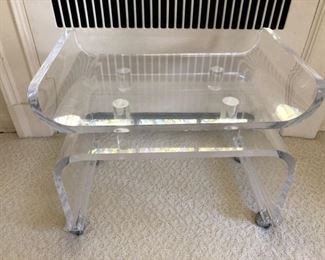 Lucite pagoda stool on casters.