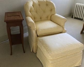 Pale yellow upholstered armchair and ottoman.