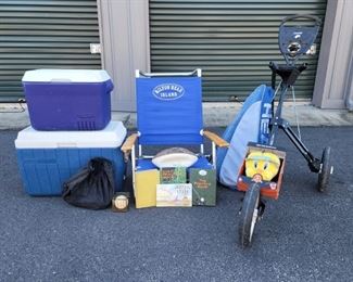 https://ctbids.com/#!/description/share/687805 Small Rubbermaid cooler is 13" tall and 17" x 12" wide. The larger coleman cooler is 17" tall and 23" x 13" wide. There are a few golfing books. A tennis racket cover, a signed football and a world series baseball. The chair is 29" tall and 19" deep. The bag boy rolling golf caddy is in good shape and has locking wheels. There is also a tweety bird golf cover.