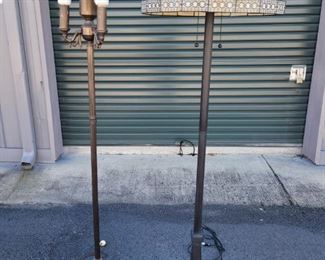 https://ctbids.com/#!/description/share/687811 One lamp has a stained glass shade and 2 pull strings to turn it on. It stands 63" tall. The base is 11" x 11" wide. The glass shade is 19" across. The other lamp is without a shade but still a beautiful decorative piece. It stands 62" tall.