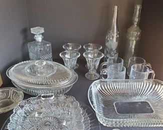 https://ctbids.com/#!/description/share/687830 Collection of glassware. Includes a 9" decanter, 13" bottles, oven proof baking dishes, trays and more.