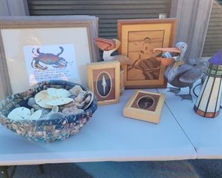 https://ctbids.com/#!/description/share/687834 Stained glass lighthouse stands 10" tall. Heart shaped basket full of shells is 11" across. Wooden pelican is 10" tall. Metal pelican is 10" tall. Crab picture is 14" x 16" . Seahorse and shell shadow boxes are both 7" x 5". Wooden lighthouse picture is 13" x 10"