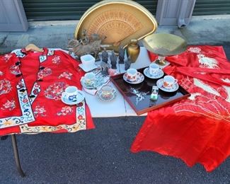 https://ctbids.com/#!/description/share/687836 2 beautiful decorative kimonos. A collection of 6 painted tea cups with saucers. 5 little figurines that are 3" to 5" tall. The metal horse is 9" tall. The golden vase and bowl are both 6" tall. The serving tray is 13" x 13"