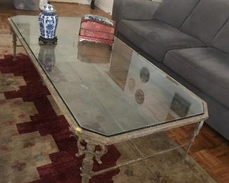 $400  Cast metal glass top coffee table.  As is, missing a bit of finish.  Length 6' x Width 34", Height 17"