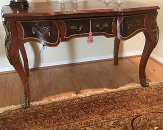 $750 Reproduction French desk with inlay and brass mounts.  Some wear, overall in good condition.  52"x30"x33"