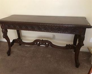 $150 Long wood side table with carving.  Bottom horizontal support needs a bit of glue.  As is.  Length 5' x  Width 20" x Height 30"  