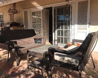 $150  Three piece plastic rattan patio set.  Two settees and matching coffee table.  One bench cushion only.  Height of settee 50" x Width 36" x Depth 26"