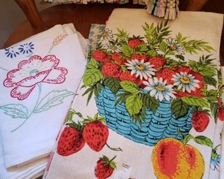 lots of vintage kitchen towels and tableclothes