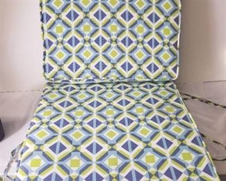 Two Colorful Patio Furniture Cushions. Attached In the Middle.
