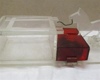 Cigarette box - The Scottie dog figure's tail when pulled back, opens up the compartment exposing where the cigarettes are stored.  It was intended to activate the music box.  The music box isn't working.  The knob just spins.  

The base is 8.5" long.