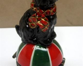 A porcelain Scottie Dog hinged Trinket  box. Figure of a dog sitting on a ball .  4" tall
