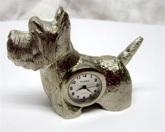 Silver tone solid metal Scottie dog figure with Timex watch size quartz clock insert.  Inside of watch not inspected, not running probably, needs new battery as the item has been in storage more than 10 years.  Dog is 2.25" tall.