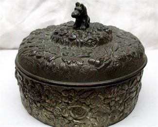 Vintage Japanese round silver plated box with cobalt glass insert.  Overall relief floral pattern and Scottie dog handle. 5.5" diameter. 

CONDITION: Chips rim of glass insert.  Lid does not fit well