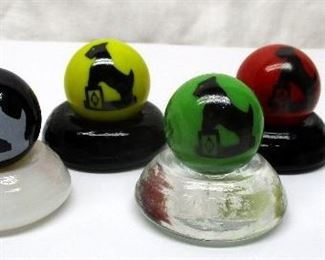 Boyd Glass marbles shooters with Scottie dog image on each.  Set of six, each with a stand.  1.25" tall including the stand. 
