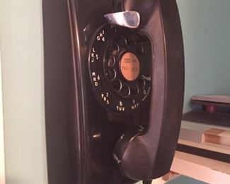 Black dial wall phone.