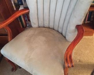 Armchair with wood handles and legs.