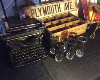 Vintage typewriters. Vintage soda boxes. Old street sign.
