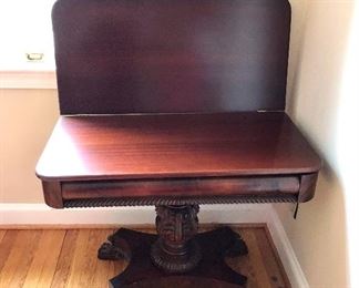 $195 - Flame mahogany, banded, pedestal , game table.  Closed: 36" W, 18" D, 27.5" H.  Open: 36" W, 36" D, 27.5" H.  