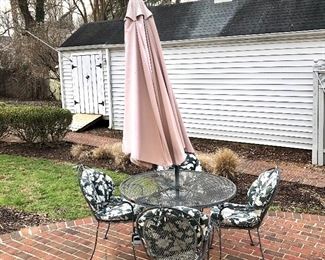$295 - Patio set with cushions (excluding umbrella).  Table: 42" diam, 29" H.  Four chairs: each 25" W, 21" D, 35" H. 
