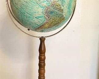 Vintage "Replogle" World Ocean Series globe on stand. 12" diameter raised relief globe. Metal base and walnut wooden spindle stand. Measures 32" tall. $60