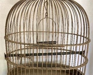 Old brass parrot cage with swing and perch, wooden top. Measures 30" tall. $65
