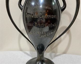 Trophy dated "1911" with the following engraving on the front "To The Honor of The City-Wide Champions In The Annual Debate Contests of the Young People's Civic League". Very descriptive and beautiful lettering. On the back it reads "Affirmative Norman A. Fraser - John W. Huling St. Stephens Epworth League 1911". Markings on the bottom is a number 964 Quadruplate Adelphi Silver Co., New York. No dents or conditions except for the quadruplate finish wear on the inside which my pictures show. Measures 11 1/2" tall, 10" wide at handles, and weighs approximately 3 1/2 lbs. $65