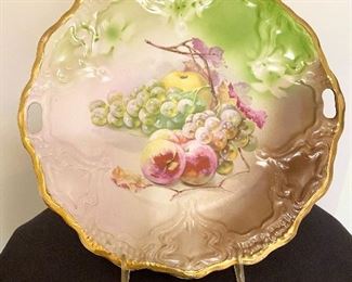 Beautiful hand painted open handled platter marked on back with "Germany" and "CT" with eagle. Measures 11" round. $24