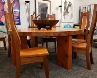 Handcrafted solid wood table and six chairs the table is 72 inch round 30 inches tall and 3 inches thick held together with iron rods the chairs are sculpted to fit your back. Wonderful set
